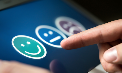 Customer selecting a satisfaction rating on a digital feedback survey
